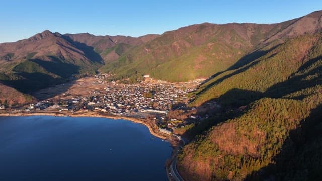 Village nestled between mountains and a lake