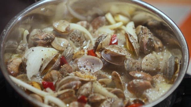 Clam Pasta Cooking in a Pot with Steam Rising