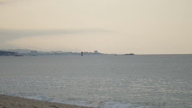Serene Seascape with Distant Lighthouse in dusk