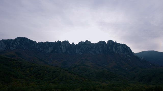 Majestic Mountain Range under a Cloudy Sky