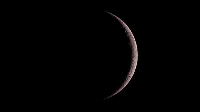 Moon shining in the dark night sky