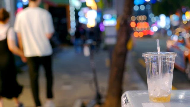 Busy city street with a discarded cup