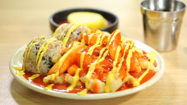 Korean tteokbokki and rice balls on a plate
