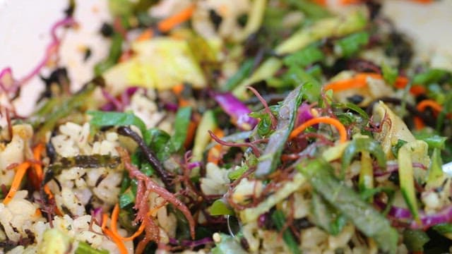 Spoonful of bibimbap with fresh vegetables and seaweed