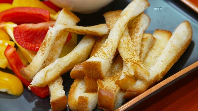 Bread with bell peppers and romesco sauce on a plate