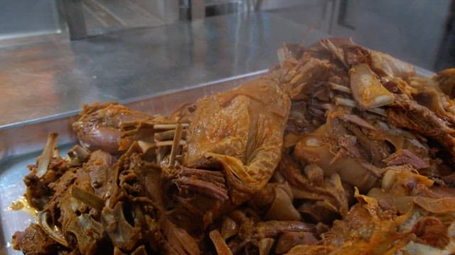 Steaming cooked meat on a metal tray