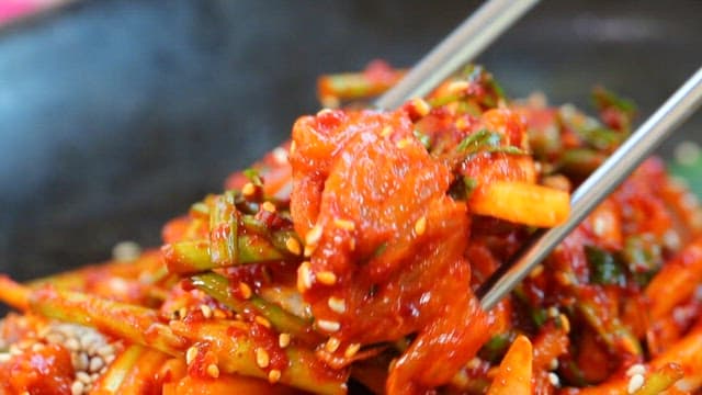 Sweet and sour pickled skate sashimi picked up with chopsticks