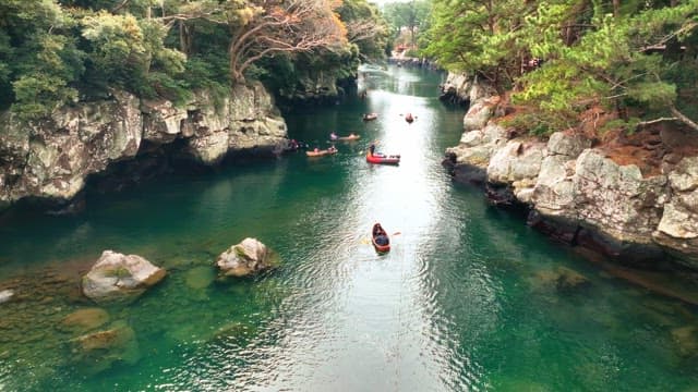 People kayaking in a scenic river