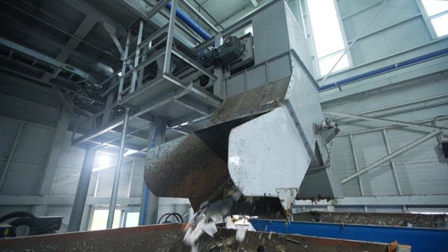 Industrial machine dumping waste indoors