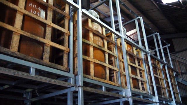 Barrels stored in a dimly lit brewing warehouse