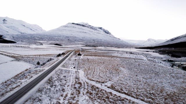 Snow-covered mountains and open road