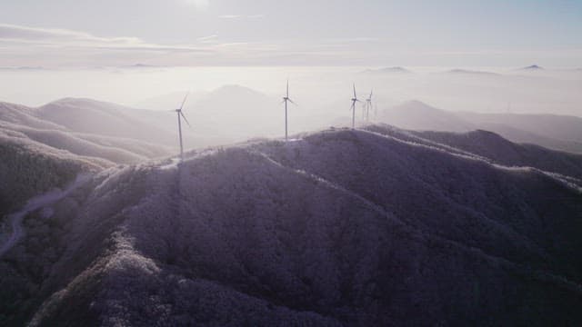 Wind turbines on Foggy Mountain Hill in the Morning