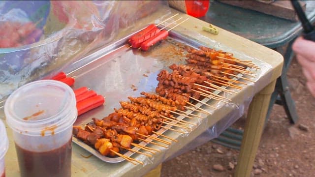 Grilled skewers and sausages on a table
