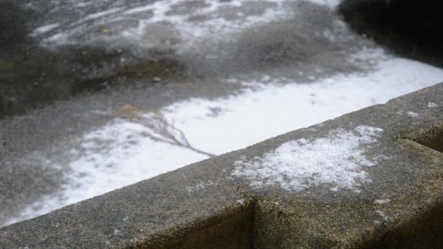 Snow-covered urban concrete surface