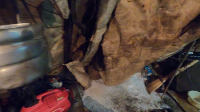 Person Taking out a Barrel from the Rent He is Staying in