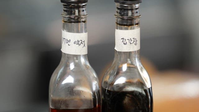 Close-up View of Two Korean Traditional Condiments in Glass Bottles
