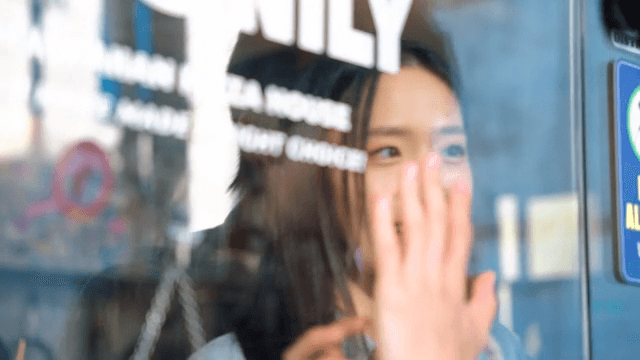 Woman welcoming a man through the glass door