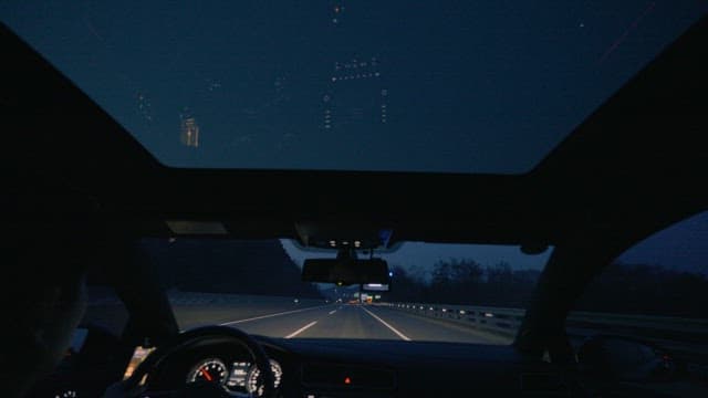Car Driving on a Quiet Highway in the Evening