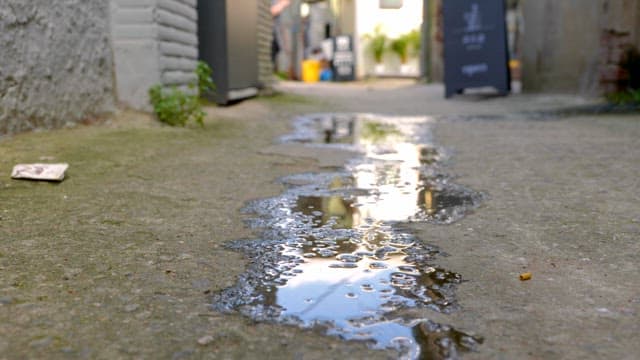 Small alley with puddles after rain
