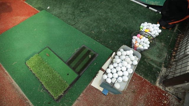 Golf practice area with balls and net