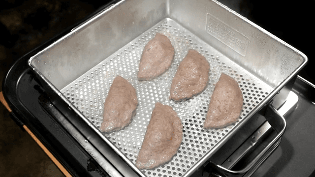 Steamed meat dumplings being cooked in a steamer