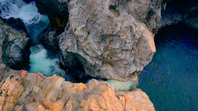Water flowing along rugged coastal rocks