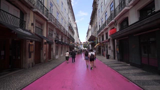 Colorful Street with Pink Pavements and Walking People
