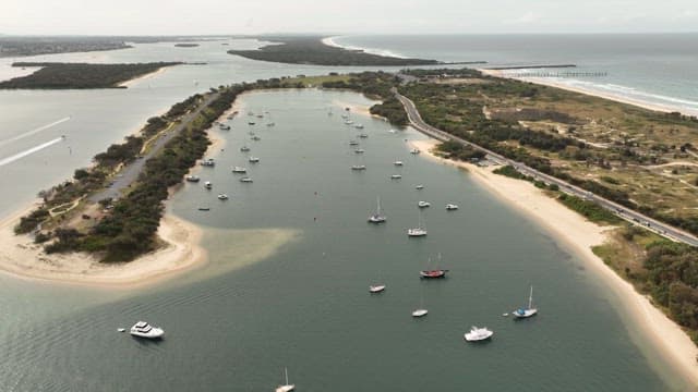 Aerial View of Boats on a Serene Coastal Inlet