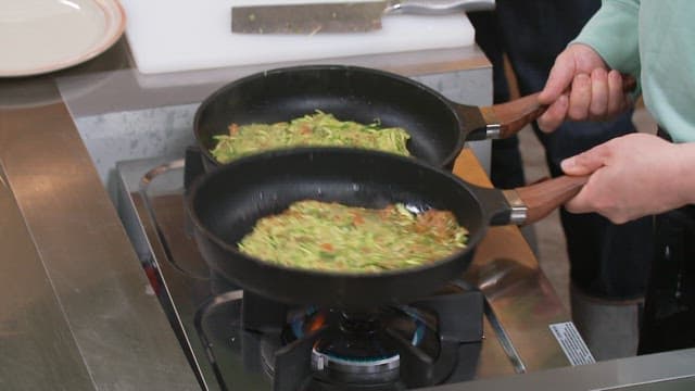 Zucchini pancakes cooked in two frying pans