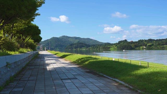 Peaceful Riverside Walkway on a Sunny Day