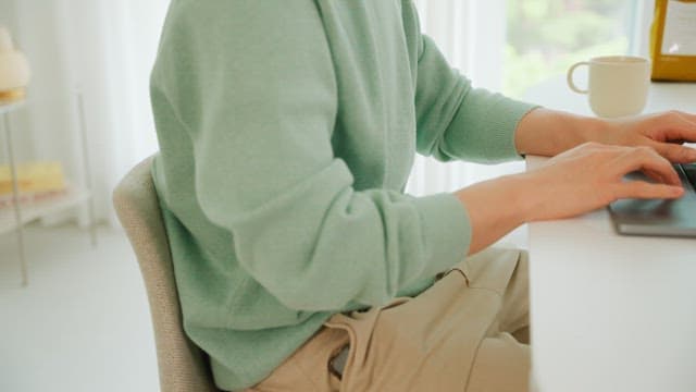Man using laptop on the white table