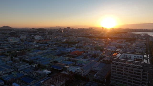 Sunset Over Urban Landscape and Sea