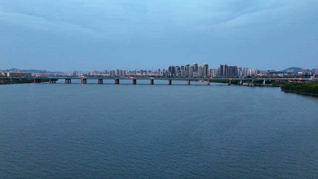 Bridge over a river with city skyline