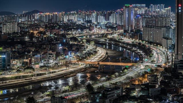 Road in Coastal City at Night with Lights