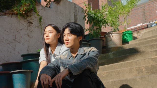 Couple sitting on outdoor steps in sunlight