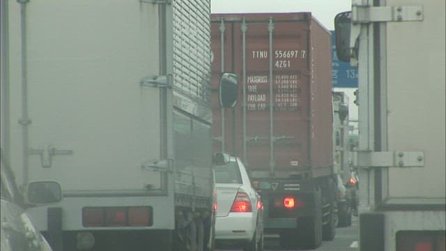 Roads clogged with trucks and cars on a cloudy day
