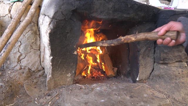 Pot Placed in an Outdoor Furnace on Fire