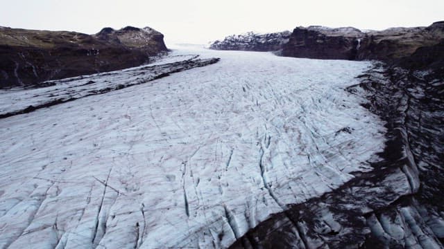 Vast glacier stretching between mountains