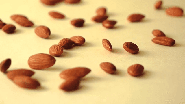 Almonds falling on yellow ground