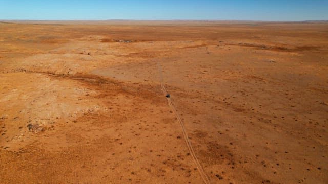 Car traveling on a remote desert