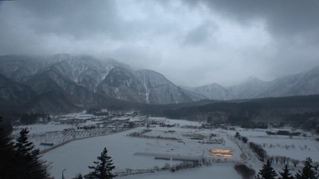 Scenery of snow-covered mountains and villages from evening to night