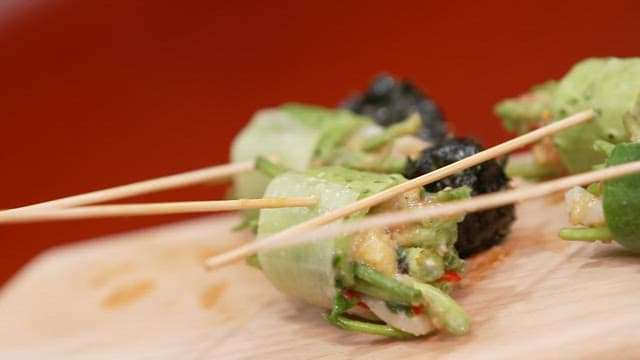 Vegetable skewers with squash and water parsley on a wooden cutting board