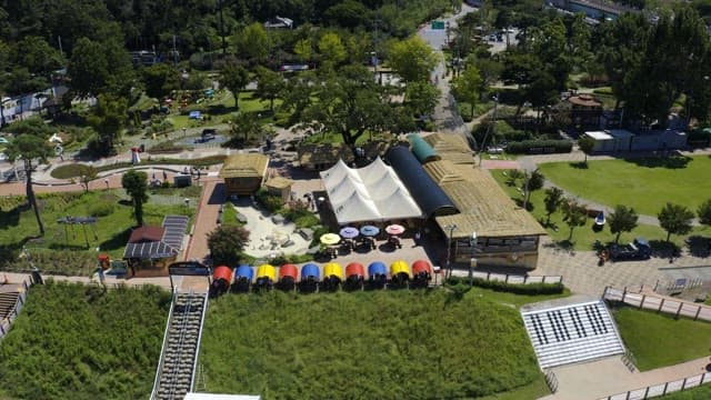 View of the park full of green and colorful structures on a sunny day