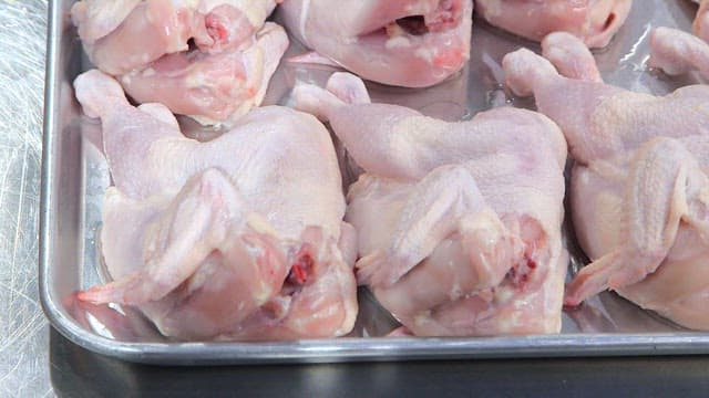 Raw chickens on a metal tray
