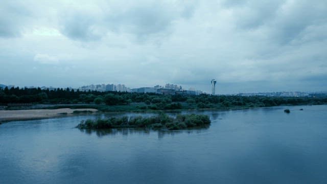 Calm river with a skyline on a cloudy day