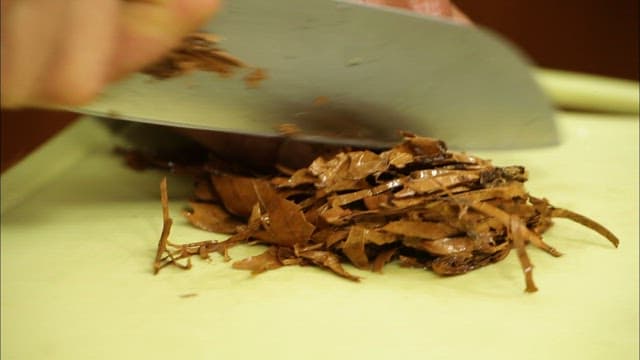 Person frying chopped ingredients in a pan