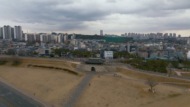Traditional Korean wall and gate in the middle of the city on a cloudy day