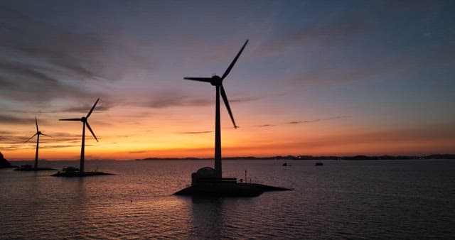 Wind Turbines at Sea During Sunset