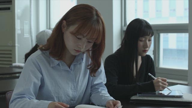 Students studying in a quiet university classroom in the afternoon