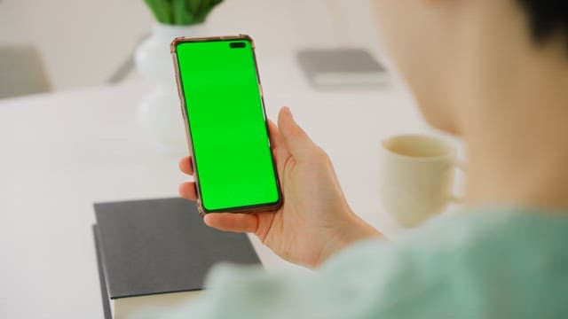 Person Using a Smartphone Indoors